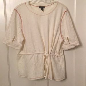 Beige top with red piping and drawstring
